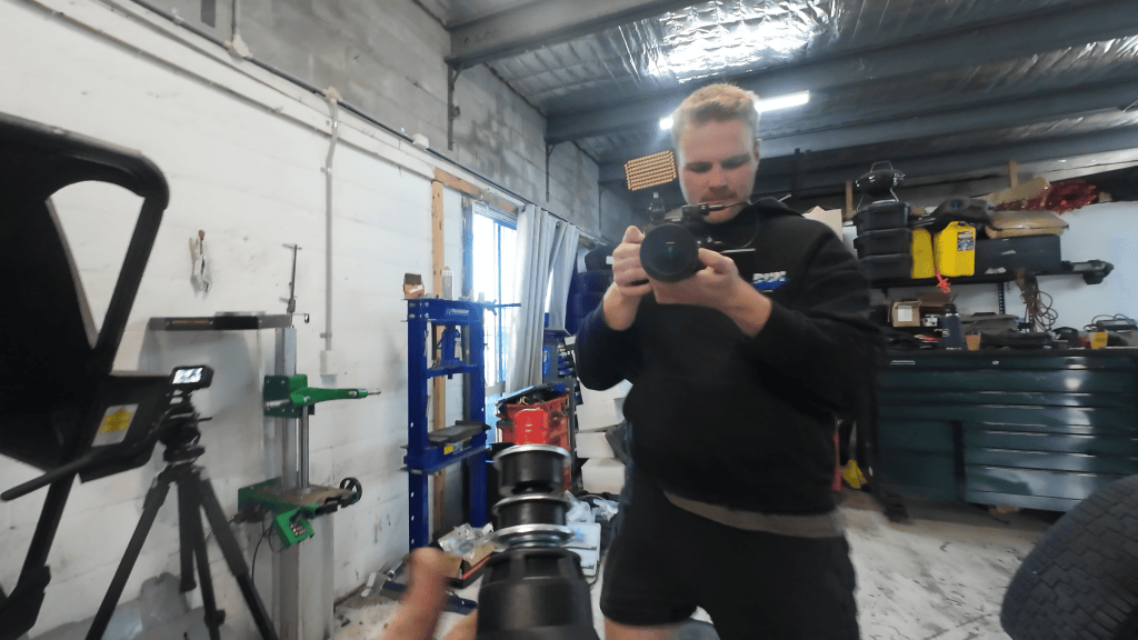 Perry filming a lift kit install at the Mechanic Near Me workshop